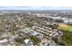 Aerial view of a residential neighborhood with colorful homes near a baseball field at 423 Shaddock St, Tarpon Springs, FL 34689