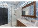 Nicely decorated bathroom featuring stylish wallpaper, vanity and modern shower at 423 Shaddock St, Tarpon Springs, FL 34689