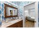 Bathroom featuring fish-themed wallpaper, a wood vanity and access to an adjacent bedroom at 423 Shaddock St, Tarpon Springs, FL 34689