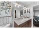 Updated bathroom with double sinks, modern lighting, and decorative wallpaper at 423 Shaddock St, Tarpon Springs, FL 34689