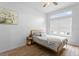 Bright bedroom with a large window and luxury vinyl plank flooring at 423 Shaddock St, Tarpon Springs, FL 34689