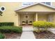 Charming front porch with seating, colorful decor, and well-maintained landscaping at 423 Shaddock St, Tarpon Springs, FL 34689