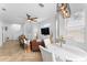Open-concept living room featuring a dining area, ceiling fan, and comfortable leather seating at 423 Shaddock St, Tarpon Springs, FL 34689