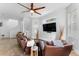 Spacious living room featuring plush seating, a ceiling fan, and an entertainment setup at 423 Shaddock St, Tarpon Springs, FL 34689