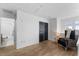 Inviting loft area with wood-style flooring, a comfortable reading chair and a view of the bathroom and ample closet space at 423 Shaddock St, Tarpon Springs, FL 34689