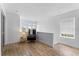 Bright loft space featuring light wood flooring, a comfortable chair, side table with lamp, and a sunlit window at 423 Shaddock St, Tarpon Springs, FL 34689