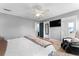 Bright main bedroom with gray walls, wood-look flooring, fan, and ensuite bathroom at 423 Shaddock St, Tarpon Springs, FL 34689