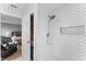 Beautifully renovated shower with white herringbone tile and a built-in niche at 423 Shaddock St, Tarpon Springs, FL 34689