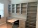 Spacious home office with custom built-in shelving and cabinets, offering ample storage and workspace at 4495 Casella Dr, Wesley Chapel, FL 33543