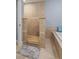 Spa bathroom with a shower stall, tiled walls, and neutral floors near a soaking tub at 4588 Baycedar Ln, Sarasota, FL 34241