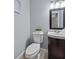 This half bathroom features stylish fixtures, a modern vanity, decorative accents and an eye catching mirror creating a chic space at 4588 Baycedar Ln, Sarasota, FL 34241