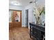 Welcoming foyer featuring wood floors, glass-paneled front doors, and a decorative console table at 4588 Baycedar Ln, Sarasota, FL 34241