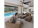 Outdoor patio with comfortable seating, ceiling fans, and views of the swimming pool and garden at 4588 Baycedar Ln, Sarasota, FL 34241