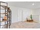 Bright hallway with a chair, neutral carpet, and display shelving adding to the home's charm at 476 Olive Conch St, Ruskin, FL 33570