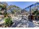 Landscaped backyard with a screened-in pool and plenty of outdoor living space at 4967 162Nd N Ave, Clearwater, FL 33760