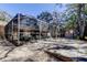 Backyard with patio, leading to a screened-in enclosure, with a glimpse of a pool at 4967 162Nd N Ave, Clearwater, FL 33760