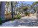 A backyard area covered with white rocks and lined with a wooden fence, providing a simple outdoor space at 4967 162Nd N Ave, Clearwater, FL 33760