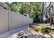 Fenced backyard with a white rock ground covering and partial view of the screened-in porch at 4967 162Nd N Ave, Clearwater, FL 33760