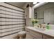 Well-lit bathroom with a shower and tub, a vanity with white countertops and a decorative mirror at 4967 162Nd N Ave, Clearwater, FL 33760