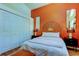 Charming bedroom featuring modern decor, orange accent wall, and ample closet space at 4967 162Nd N Ave, Clearwater, FL 33760
