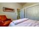 Bright bedroom with a window, a comfortable armchair, and access to a full bathroom at 4967 162Nd N Ave, Clearwater, FL 33760