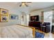 Comfortable bedroom featuring a ceiling fan, a television, a patterned rug and stylish decor at 4967 162Nd N Ave, Clearwater, FL 33760