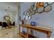 Stylish entryway with modern mirror decor, wood accent table, and dining area view at 4967 162Nd N Ave, Clearwater, FL 33760