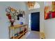 Elegant foyer showcasing a blue front door, decorative mirrors, and a stylish accent table at 4967 162Nd N Ave, Clearwater, FL 33760