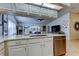 Open kitchen includes white cabinets, quartz countertops, and stainless steel dishwasher at 4967 162Nd N Ave, Clearwater, FL 33760