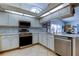 Bright kitchen showcases stainless steel appliances, white cabinetry, and marble backsplash at 4967 162Nd N Ave, Clearwater, FL 33760