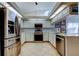 Well-equipped kitchen with stainless steel appliances, white cabinetry, and ample counter space at 4967 162Nd N Ave, Clearwater, FL 33760