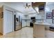 Open kitchen with stainless steel appliances, white cabinetry, and tiled flooring at 4967 162Nd N Ave, Clearwater, FL 33760