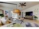 Bright living room boasts vaulted ceiling, ceiling fan, and sliding door access to the patio at 4967 162Nd N Ave, Clearwater, FL 33760