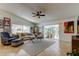 Cozy living room features a vaulted ceiling, ceiling fan, and access to patio through sliding doors at 4967 162Nd N Ave, Clearwater, FL 33760