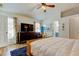 Bright bedroom with patterned curtains, wood floors, and ensuite bathroom at 4967 162Nd N Ave, Clearwater, FL 33760