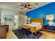Spacious bedroom with a blue accent wall, wood floors, and a ceiling fan at 4967 162Nd N Ave, Clearwater, FL 33760