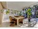 Relaxing screened patio with comfortable lounge seating and leafy potted plants at 4967 162Nd N Ave, Clearwater, FL 33760