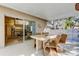 Covered patio with dining table near sliding door leading to kitchen at 4967 162Nd N Ave, Clearwater, FL 33760