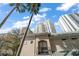 Balcony view showcasing nearby high-rise buildings against a blue sky with palm trees at 501 Knights Run Ave # 2101, Tampa, FL 33602