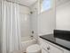 Bathroom features a shower with marble tiling, bathtub, and vanity with black counter at 501 Knights Run Ave # 2101, Tampa, FL 33602