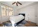 This is a bright bedroom with wood floors, a fan, a window, and a small night stand at 501 Knights Run Ave # 2101, Tampa, FL 33602