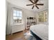 Bright bedroom with wood floors, natural light from two windows, and a bookshelf in the corner at 501 Knights Run Ave # 2101, Tampa, FL 33602
