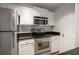 The kitchen offers stainless steel appliances, granite countertops, white cabinetry, and tile backsplash at 501 Knights Run Ave # 2101, Tampa, FL 33602