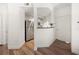 Hallway leading to kitchen with stainless steel appliances, white cabinets, and black granite countertops at 501 Knights Run Ave # 2101, Tampa, FL 33602