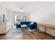 Bright living room features a blue sectional sofa, wood floors, and sliding glass doors to a balcony at 501 Knights Run Ave # 2101, Tampa, FL 33602