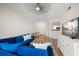 Open-concept living room with wood floors, a blue sofa, and access to the kitchen at 501 Knights Run Ave # 2101, Tampa, FL 33602