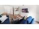 Open-concept living room with a blue sectional, wood floors, and views of the kitchen area at 501 Knights Run Ave # 2101, Tampa, FL 33602