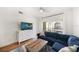 Cozy living room with a blue sectional sofa, wood floors, balcony access, and a white media center at 501 Knights Run Ave # 2101, Tampa, FL 33602