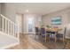 Dining area with a wooden table, blue chairs, and wood-look tile flooring at 5087 San Martino Dr, Wesley Chapel, FL 33543