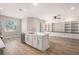 Stylish kitchen island overlooking a bonus room with custom shelving at 5087 San Martino Dr, Wesley Chapel, FL 33543